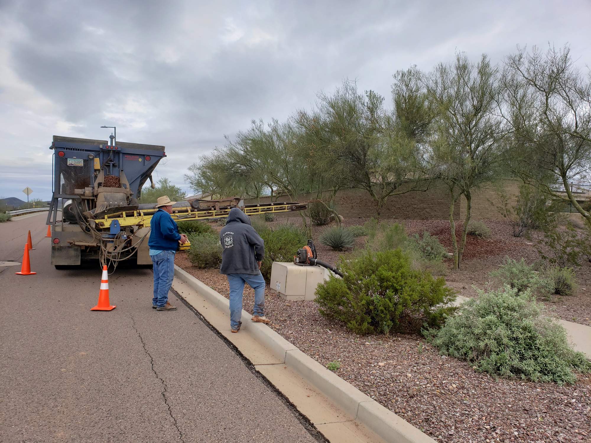 Rock Spreaders crew refreshing gravel along an Arizona roadside